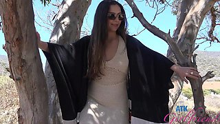 A cute brunette girl with long hair has fun with her boyfriend outdoors