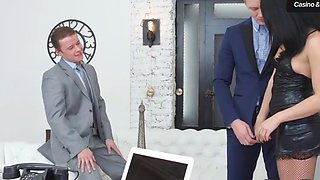 Two fellows in suits share a cumshot on a desk
