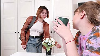 Redhead and blonde teen finger each other’s shaved pussies in a steamy lesbian scene.