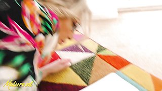 Rosie strips to white lace bra and panties on colorful geometric rug