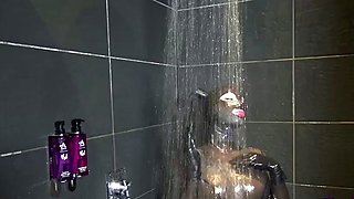 Busty MILF vixen in latex plays with herself in the shower