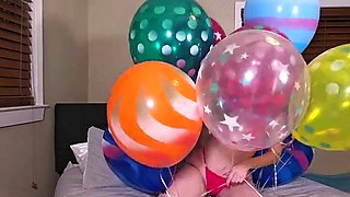 Playing young milf having fun with balloons on the bed