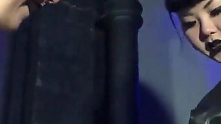 Lady Valeska and Miss Patricia have their sub over a bench.