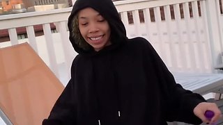 Ebony babe plays with a vibrator on a rooftop showing you her beefy lips