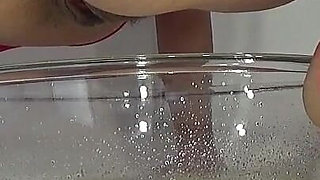 A MILF in Red Is Peeing Into a Basin.