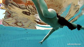 Foxy starlet with small tits strips down in the pool
