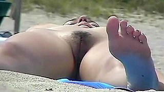 Busty girl shows her mighty jugs on a nudist beach