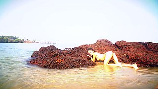 Hot teen stripping seductively and posing naked on the beach