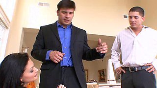 In a kitchen a sexy brunette playing with her big boobs