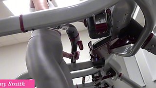 Athletic milf with big tits exposes her rack while working out in gym