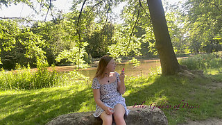 Innocent Girl Sits in the Park and Eats Lollipop Not Knowing That Her Panties Can Be Seen
