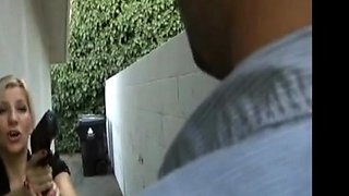 In a kitchen a sexy brunette playing with her big boobs