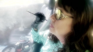 MATURE BRUNETTE MRS. ROMAN CAR SMOKING HER MORE 120 MENTHOLS IN HER BLACK CIGARETTE HOLDER