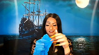 Dominatrix Nika with a glove fetish puts on medical gloves and destroys them with her long tools