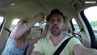 First hands on the steering wheel then mouth on the cock