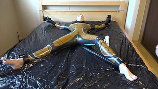 Latex Danielle is attached to the bed and masturbated with the massage vibrator