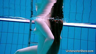 Beautiful amateur gal enjoys nude swim show in the pool