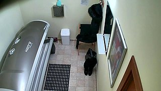 Red MILF rubs her pussy in solarium