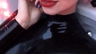 Dhorny redhead in latex sucks a huge penis