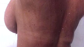 Busty curly brunette with big boobs fucks on couch