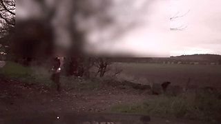 Wanking  in body stocking dodging cars that pass by