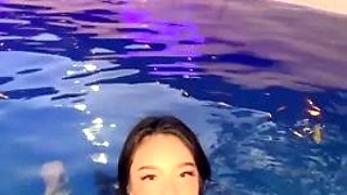 Exotic bombshell performs sensual striptease in the pool