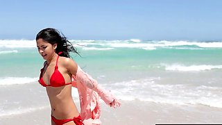 Cute nude asian babe posing at the beach