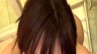 A Smooth-skinned Beauty Shares a Tender Moment Beneath the Warmth of the Shower.