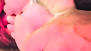 Sucking her toes while she watches a movie