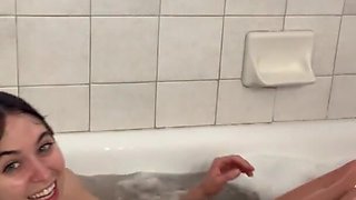 Cute tiny brunette stimulates her anal hole in shower with a dildo