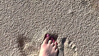Comparing Size 16 Feet to Sand Prints at the Beach