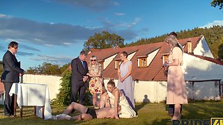 A hot bride is getting fucked outdoors by her husband in a steamy scene