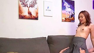 A slim Asian woman demonstrates off her diminutive tits
