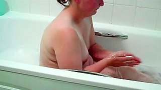 Mature British BBW with saggy tits takes a bath naked