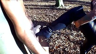 Milf goddess punishes masked slave's cock and balls outdoors