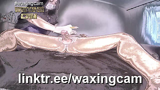 A Nurse in White Gloves Waxes a Guy