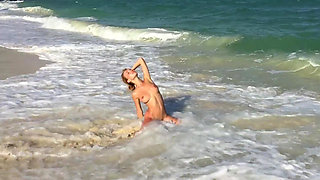 Young beauty Delilah G on the beach