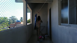 She is naked hanging the laundry out to dry
