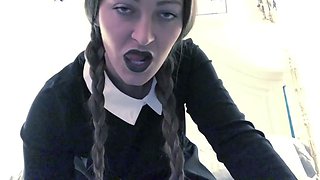 Braided woman in a black dress and pantyhose uses a fucktoy