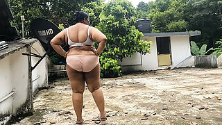 A Full-figured Woman in a White Skirt and Pink Top Strips Down and Walks Nude Outside