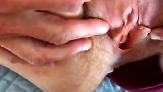 parting her panties to show hairy pussy and hard clit