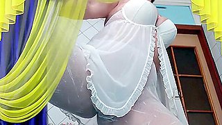 A Hot Housewife In The Kitchen Wears White Transparent Pantyhose Without Panties And A White Peignoir In Which Her Tummy