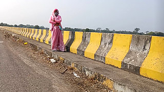 Sister-in-law is walking on the bridge by the roadside, getting down on the shore, sister-in-law started taking her clothes from the toilet and fingering her pussy.
