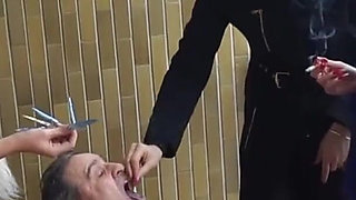 Fur-clad Femdoms Dominate Submissive on Balcony