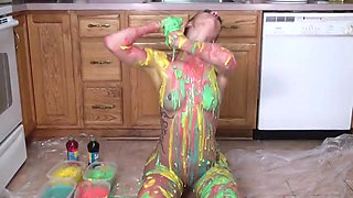 Hot girl puts colors  all on her tits and her pussy in the kitchen