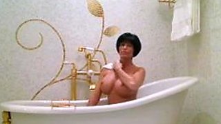 Busty curly brunette with big boobs fucks on couch