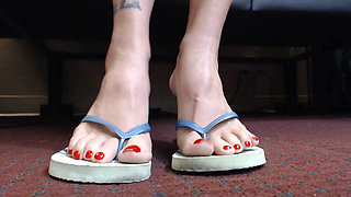 Pretty red toenails in flip flops