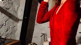 Seductive housewife posing in sexy red Christmas dress